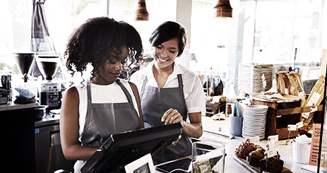 New Employee Receives Training At Delicatessen Checkout