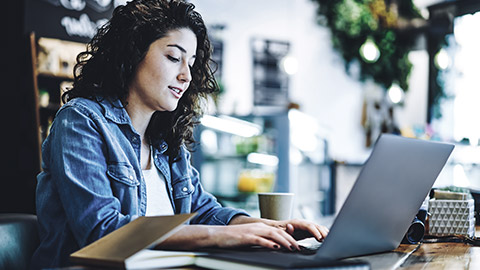 Casual woman typing on computer