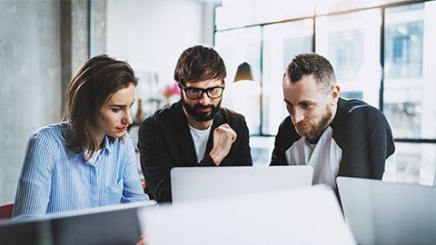 Group of colleagues working and brainstorming at a modern office