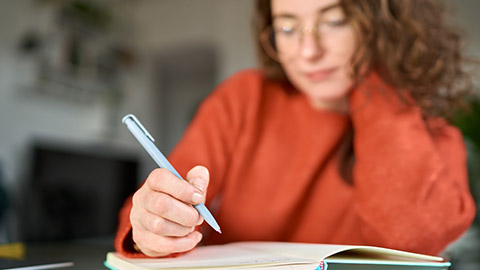 A person writing in a journal