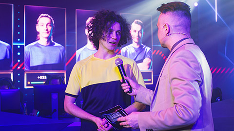 A presenter interviewing an eSports player