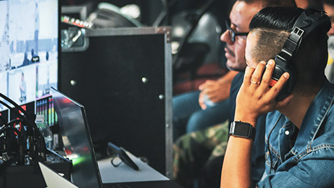 A close view of technicians watching the action live on screen