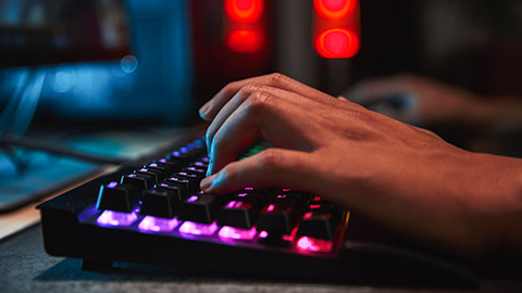 A close view of a player typing on a keyboard