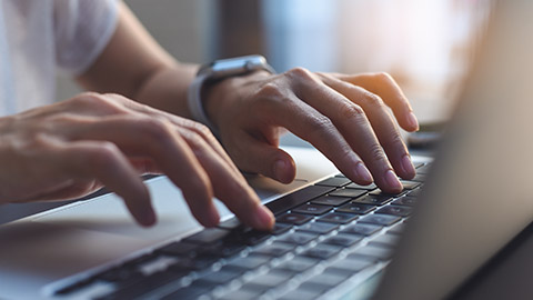 A close view of a person typing on a laptop keyboard