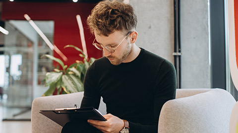 An event planner writing details on a notepad