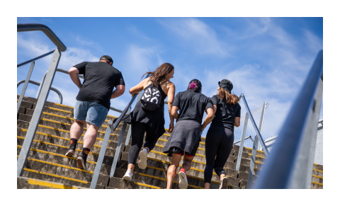 A group of people running up the stairs