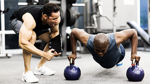 A trainer pumping up a client