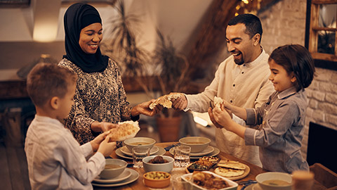 A family sharing a meal at night during Ramadan