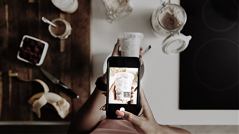 A person taking a photo of the back of a food package