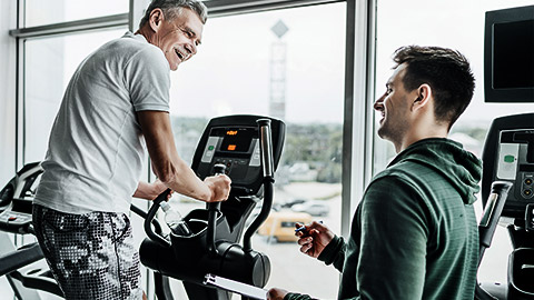 A trainer talking to an elderly client