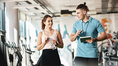 A young trainer engaging postively with a client