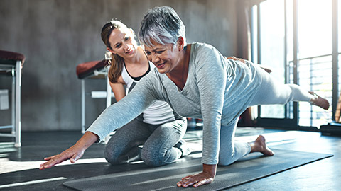 An elderly client doing stretches