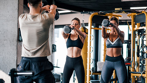 A trainer working with 2 clients