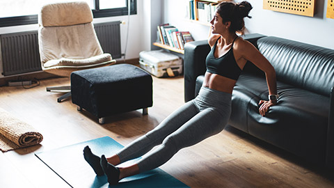 A lady doing a workout in her lounge room