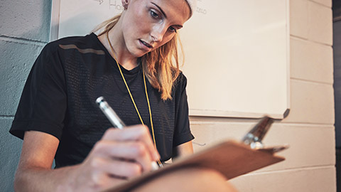 A trainer filling out paperwork