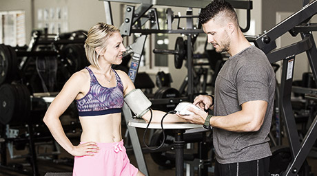 A gym member talking to a trainer