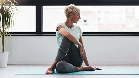 A mature lady doing stretching exercises