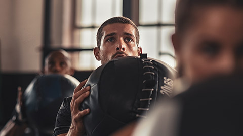 A close view of a person taking part in an intense workout in a gym setting