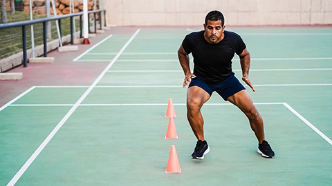 A person doing speed drills on a basketball court