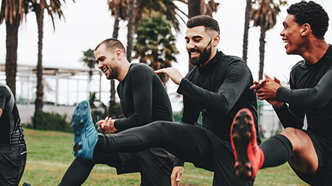 A group of football players doing dynamic stretches before a game