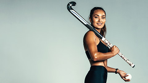 A smiling field hockey player