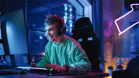 Portrait of a Happy Gamer Winning a Round in Online Video Game on Personal Computer