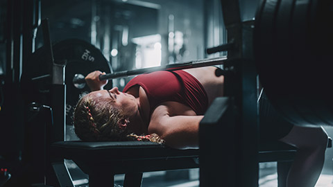 A person doing a bench press with heavy weight