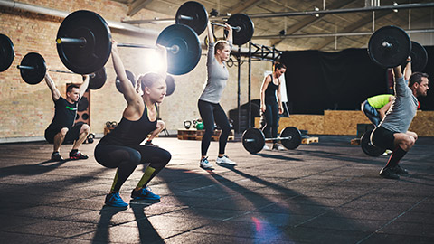 A group lifting weights together at a gym