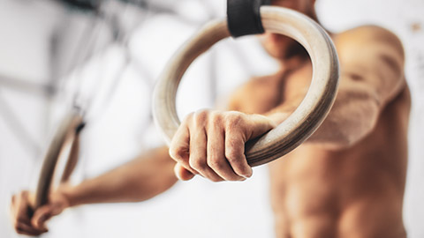 A close view of a gymnast using the rings