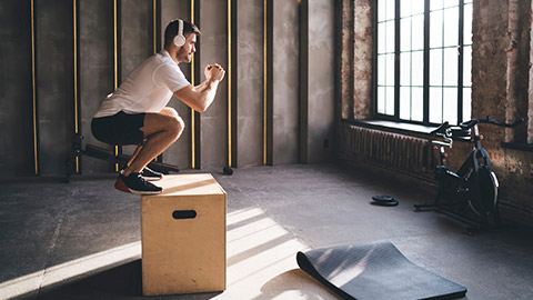 A person doing box jumps