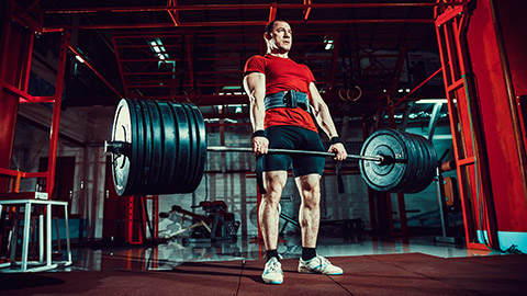 A person power lifting in a gym