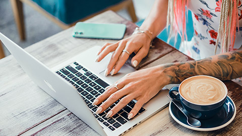 A fitness instructor working on a laptop