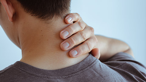 A close view of a person with neck pain