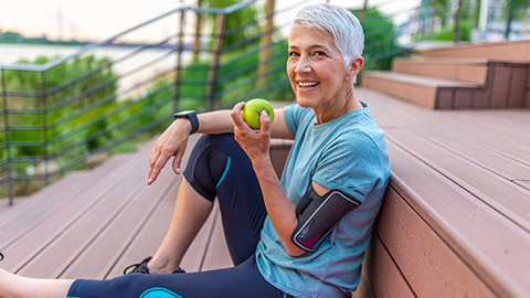 A mature person eating fruit after exercise