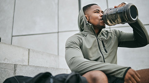 A person drinking water before exercise