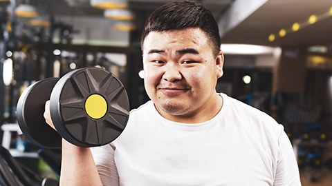 An overweight male lifting weights