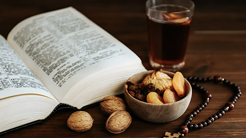 Bible, dried fruits, and wooden rosary