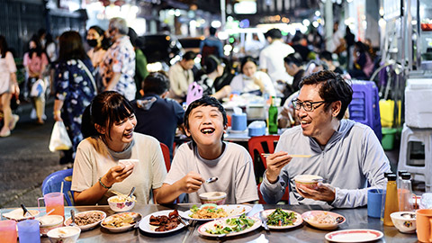 Family in Thailand enjoying streetfood