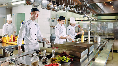 Modern kitchen. The chefs prepare meals in the restaurant's kitchen.