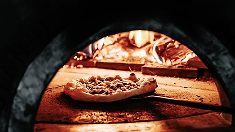 Cooking pizza in oven-brick