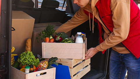 A person delivering supplies to a restaurant