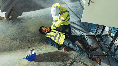 An electrician assessing a coworker who has been electrocuted