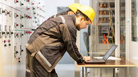 Electrician coworkers checking legislation information relating to their job