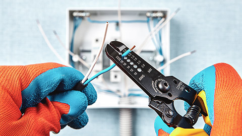 A close view of an electrician working with wires