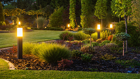 A backyard with exterior lighting