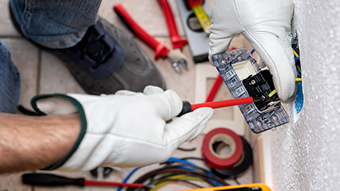 Top down view of an electrician working on a switch