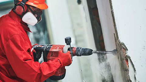 A person using using safety and PPE measures