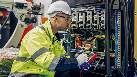 Technician engineer holding robot controller checking and repairing