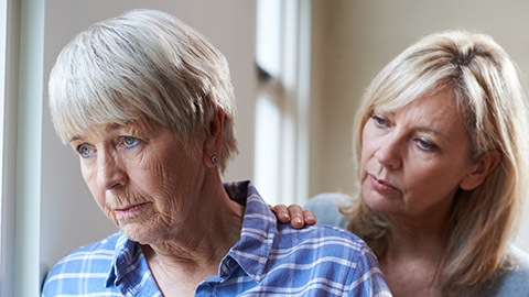 Serious Senior Woman With Adult Daughter At Home