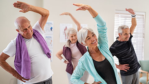 A group of elderly people exercising